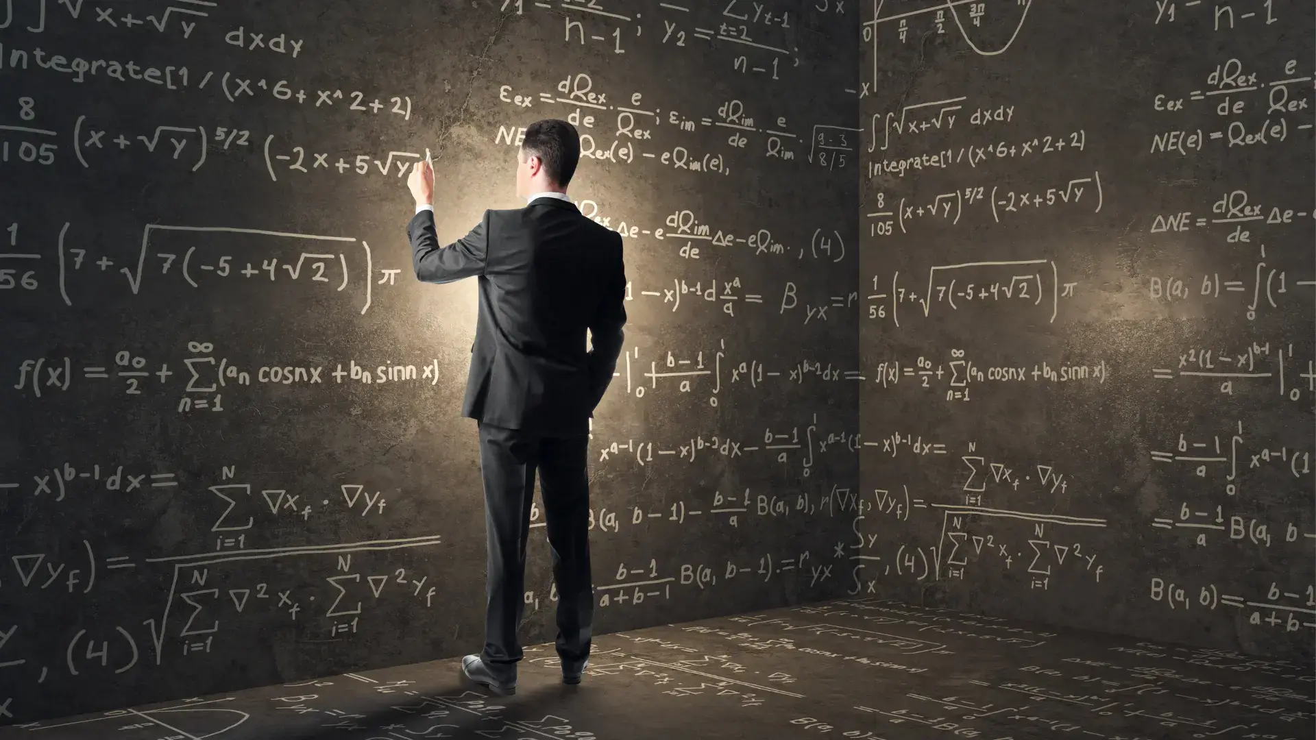 A man writing a complex algorithm on a chalk board. 