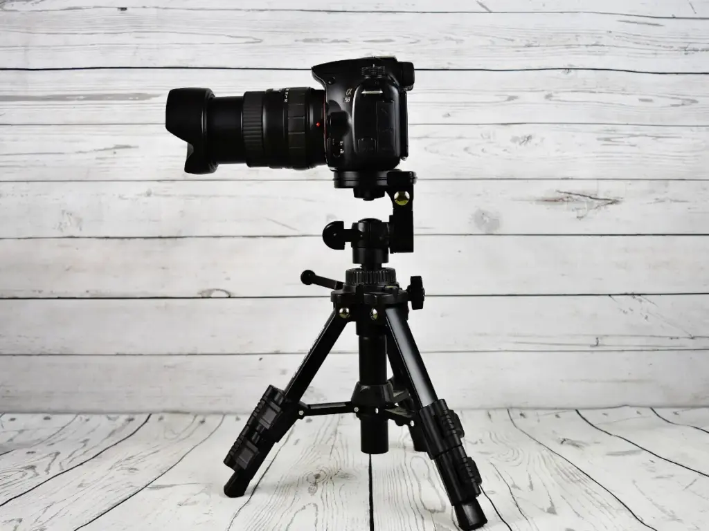 A digital camera sitting on a tripod.