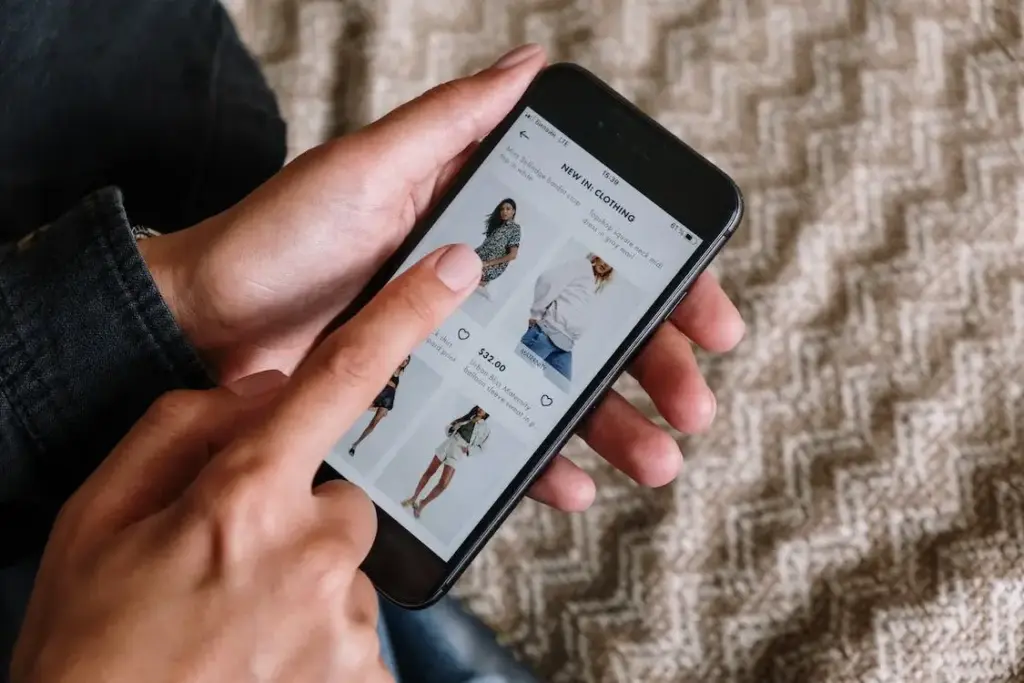 A person shopping for clothing on their phone.