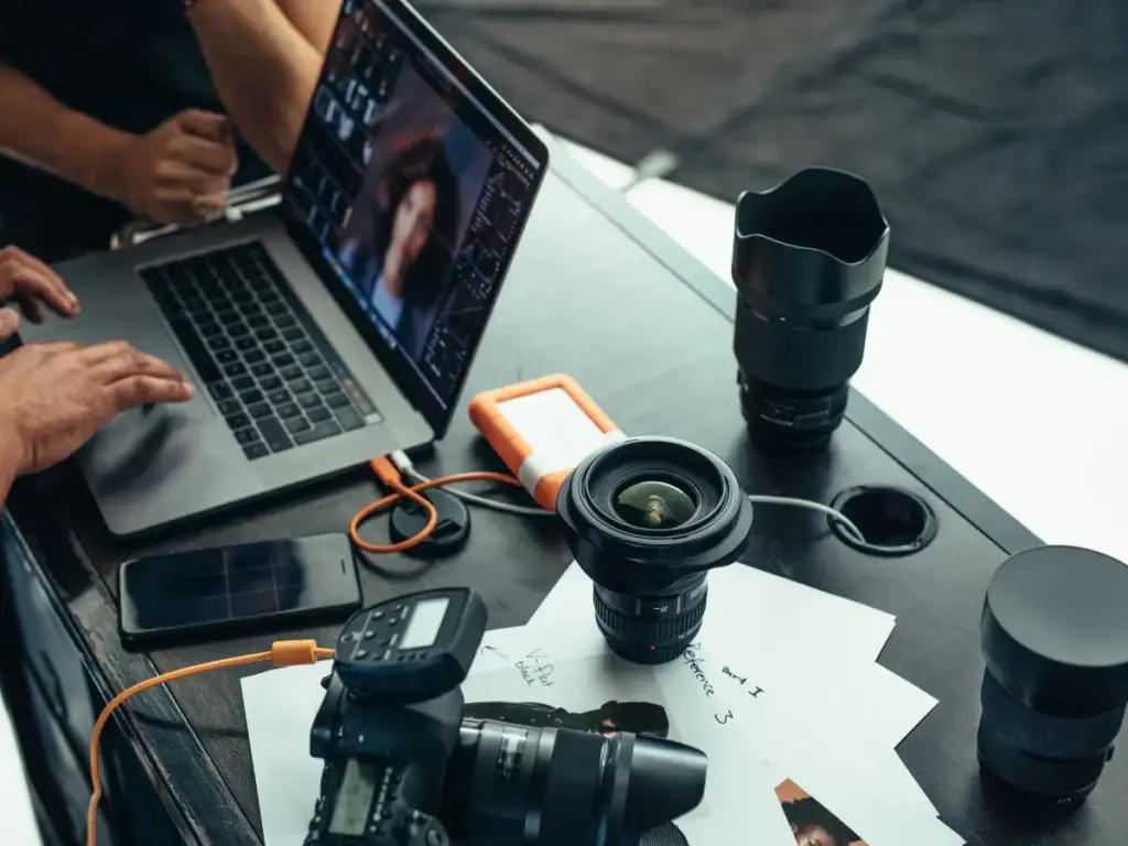 A photographer working to resize images on their laptop.